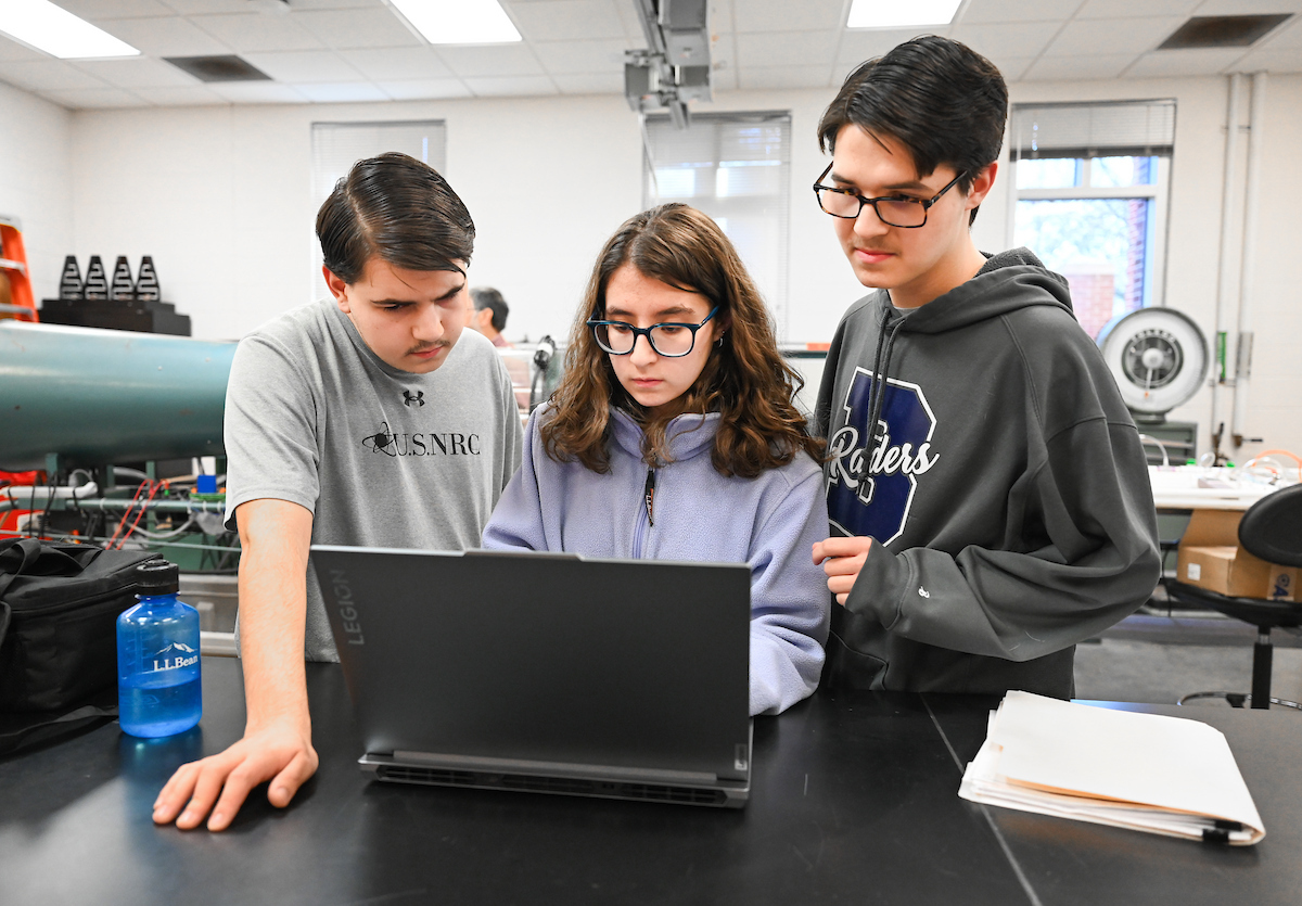 The Riggs triplets—Luke (left), Isabella and Matthew—work in Dr. Reetesh Ranjan's fluid mechanics laboratory in the Engineering and Computer Science building.