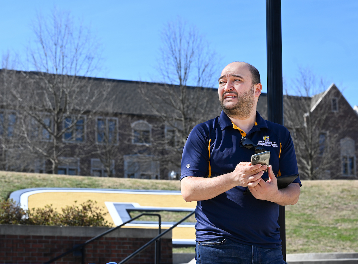 Gokhan Erdemir, Ann McAbee and Trevor Kight work Friday, Feb. 28, 2025 on Chamberlain Field to gather data from two robotic dogs, Spot and Goddard. The data will be compared against data from real dogs and used to make the robots move more like real dogs.