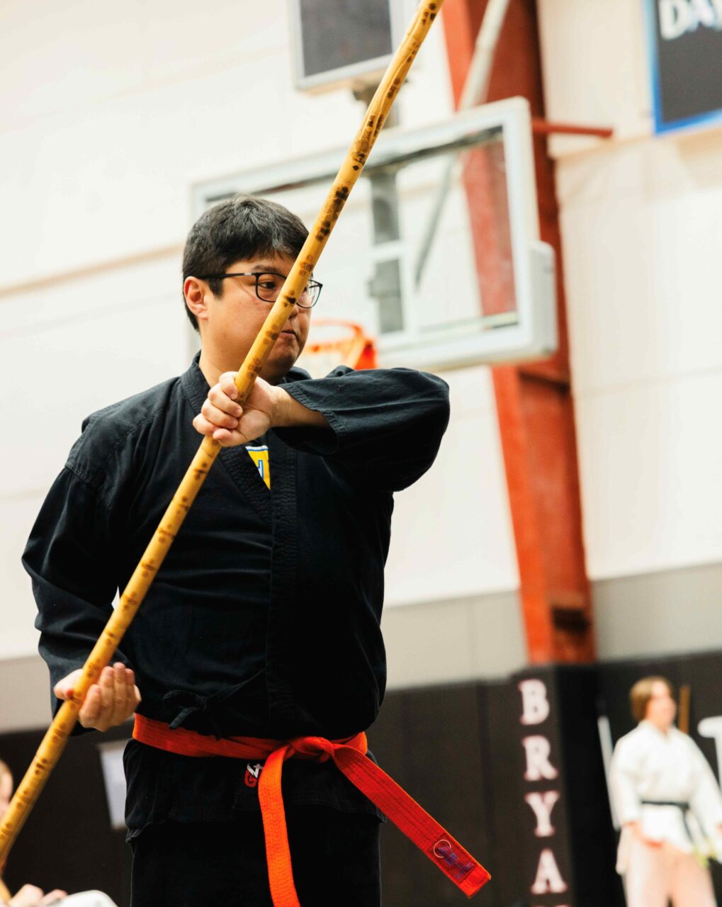 Visiting Assistant Professor of Psychology Duncan Overton, who finished first in both men’s beginners weapons and men’s beginners kata and fourth in men’s beginners kumite, wields the bo (photo credit: Bryan College).