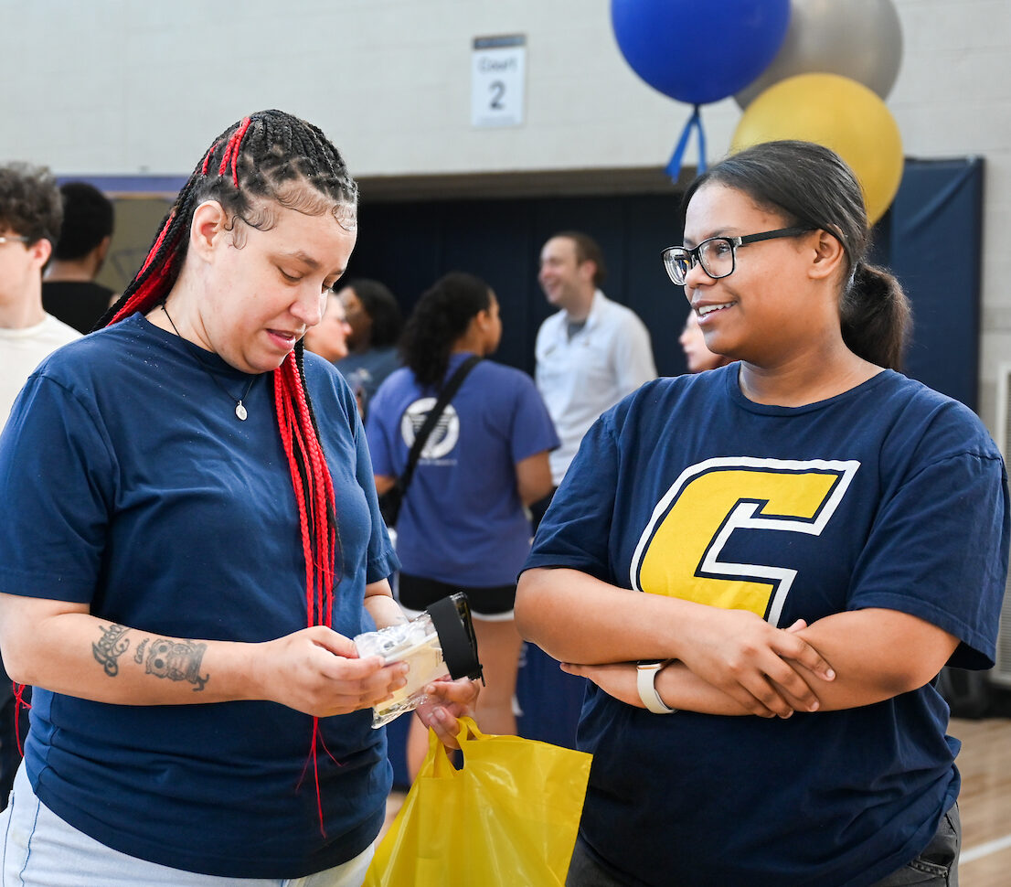 Ashley Fugate (left) and her daughter Avery Cross attend the Blue and Gold Spring Preview on Saturday, April 5. Photo by Angela Foster.