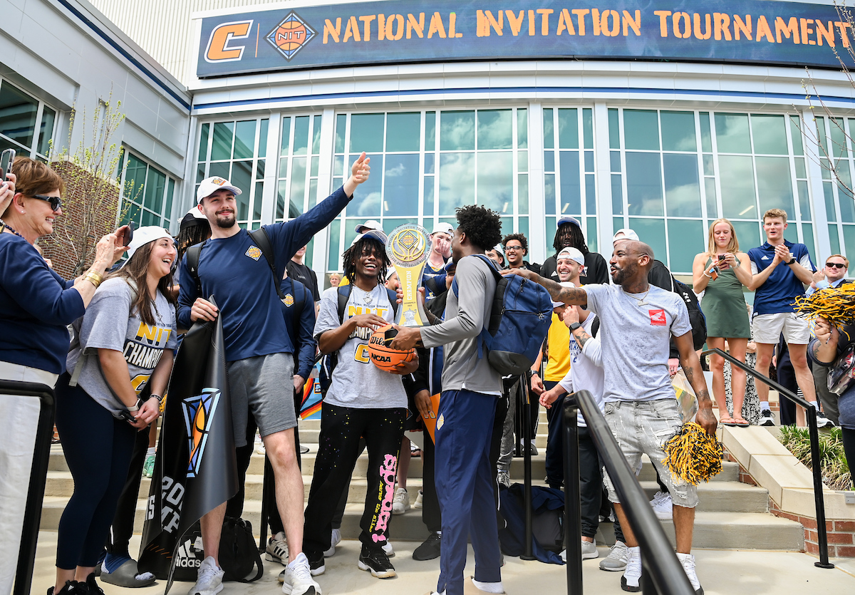 The Chattanooga Mocs men's basketball team arrived home to a celebration outside of McKenzie Arena. Photo by Angela Foster.