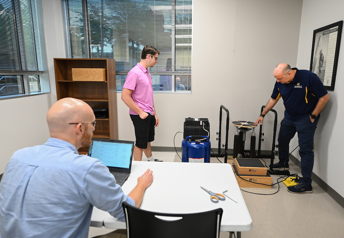 Dr. Max Jordon (sitting), Austin McDade and Dr. Erkan Kaplanoglu