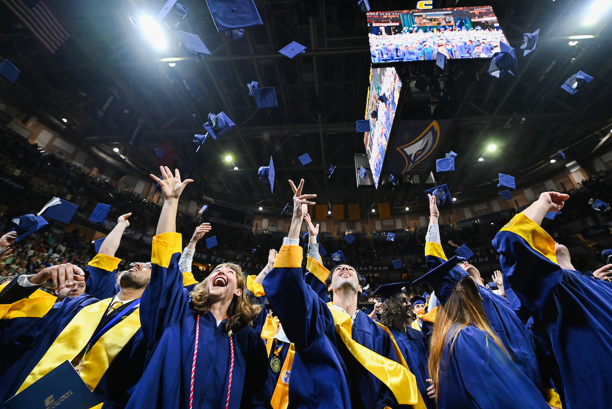 Students toss their caps at the end of UTC's undergraduate commencement ceremony for the College of Arts and Sciences and the College of Engineering and Computer Science on Saturday, May 3. Photo by Angela Foster.