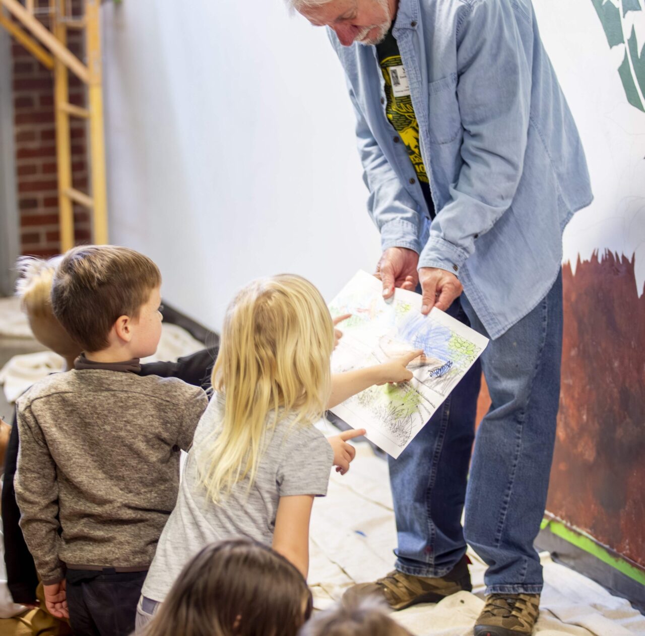 Artist David Riall comparing children's versions of the mural imagery with Chattanooga School for the Arts & Sciences  kindergarten students. Photo courtesy of Arts-Based Collaborative.