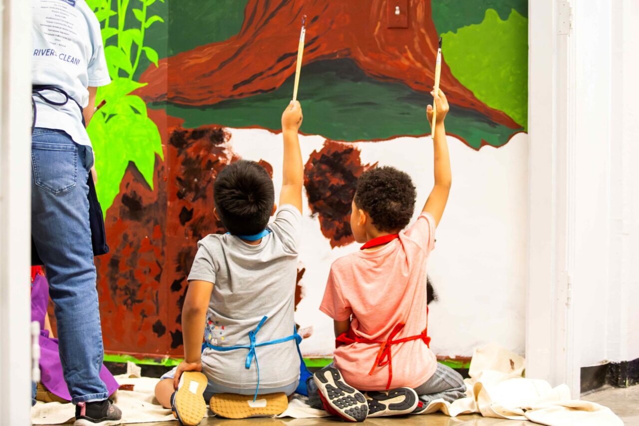 Two kindergarten artists finishing their contributions to the Chattanooga School for the Arts & Sciences mural project. Photo courtesy of Arts-Based Collaborative.