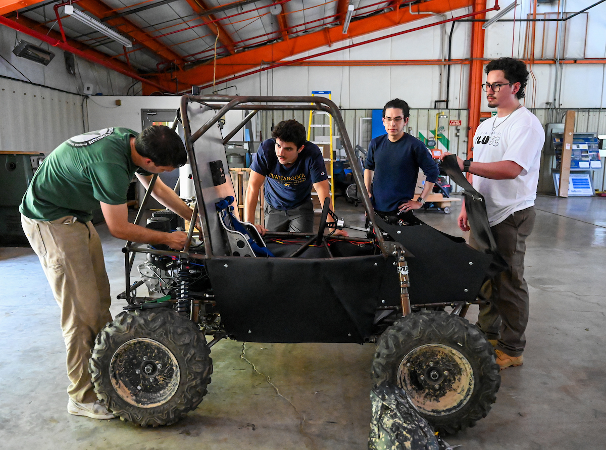 Eric Perez (second from right in solid blue shirt) is a UTC senior mechanical engineering major and a 3D design modeler for Astec Industries.