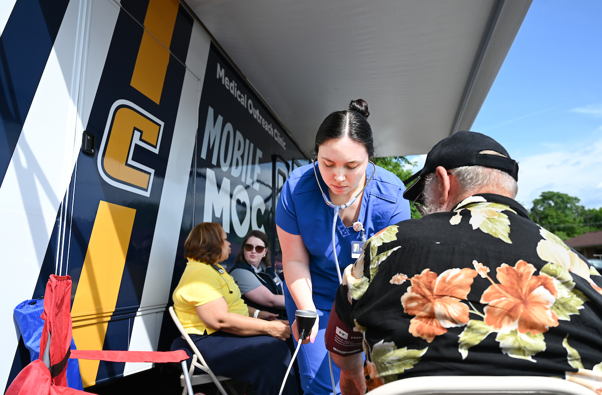 Carly Chastain takes a patient's blood pressure.