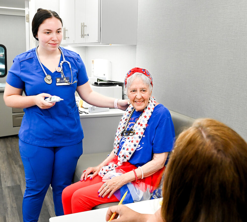 Carly Chastain (left) treats DeAnna Grove in the MobileMOC health clinic. Photo by Angela Foster.