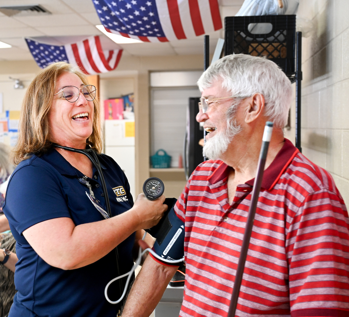 Dr. Kristi Wick takes a patient's blood pressure in the Rhea Richland Senior Neighbors Center.