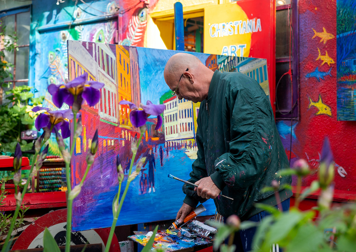 Artist Marios Orozco painting in front of the Christiania Art Gallery in Copenhagen, Denmark.