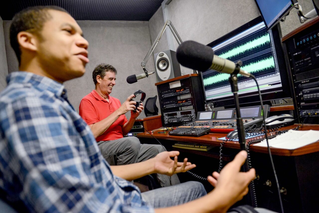 Richard Winham records an episode of "The Thursday Encounter" with student intern Kinnawa Kaitibi in 2014. Photo courtesy of WUTC.