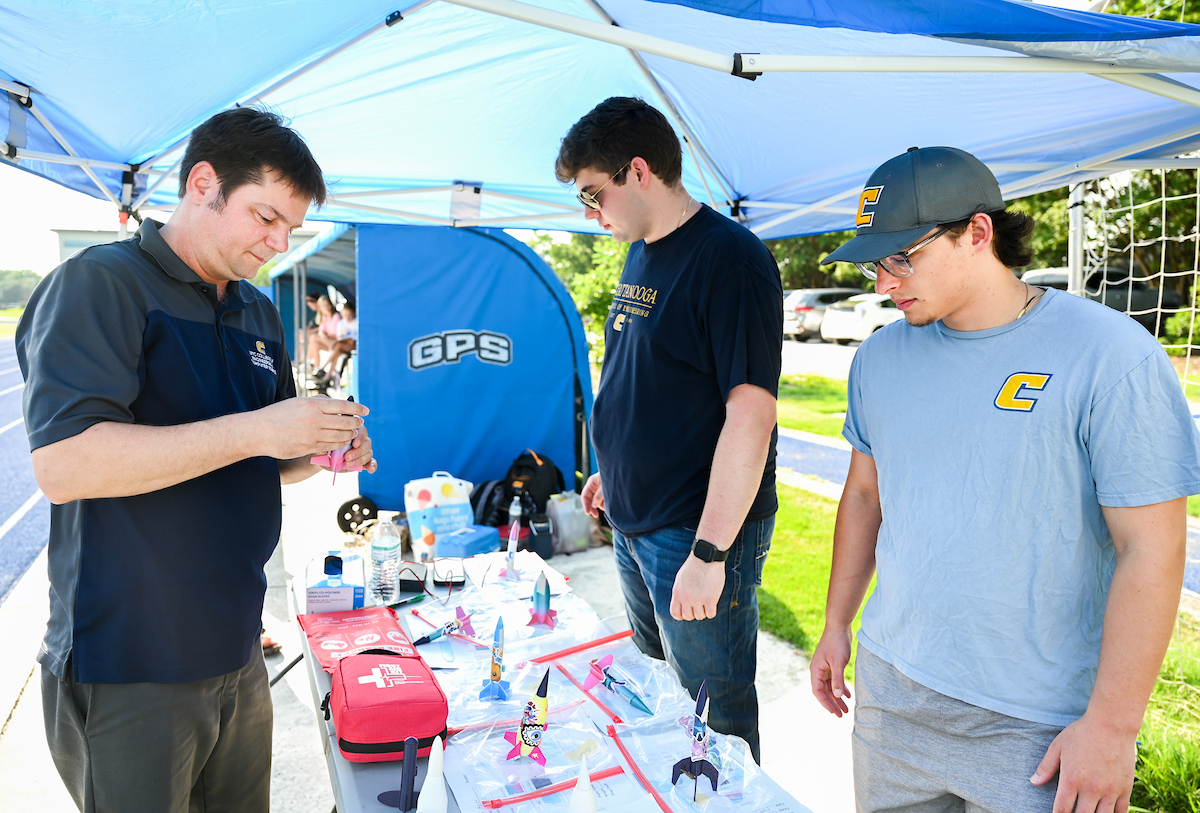 Dr. Trevor Elliott, left, Rett Stockman and Gabe Mejia led the summer camp experience, working with the students to launch the rockets.