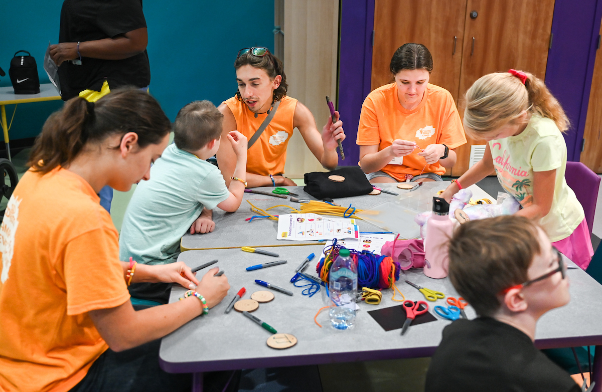 Psychology students work with Friends Discovery Camp campers Thursday, June 12, 2025 at the Creative Discovery Museum.