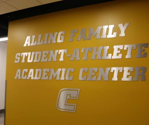 The sign reading Alling Family Student-Athlete Academic Center on the wall outside the center