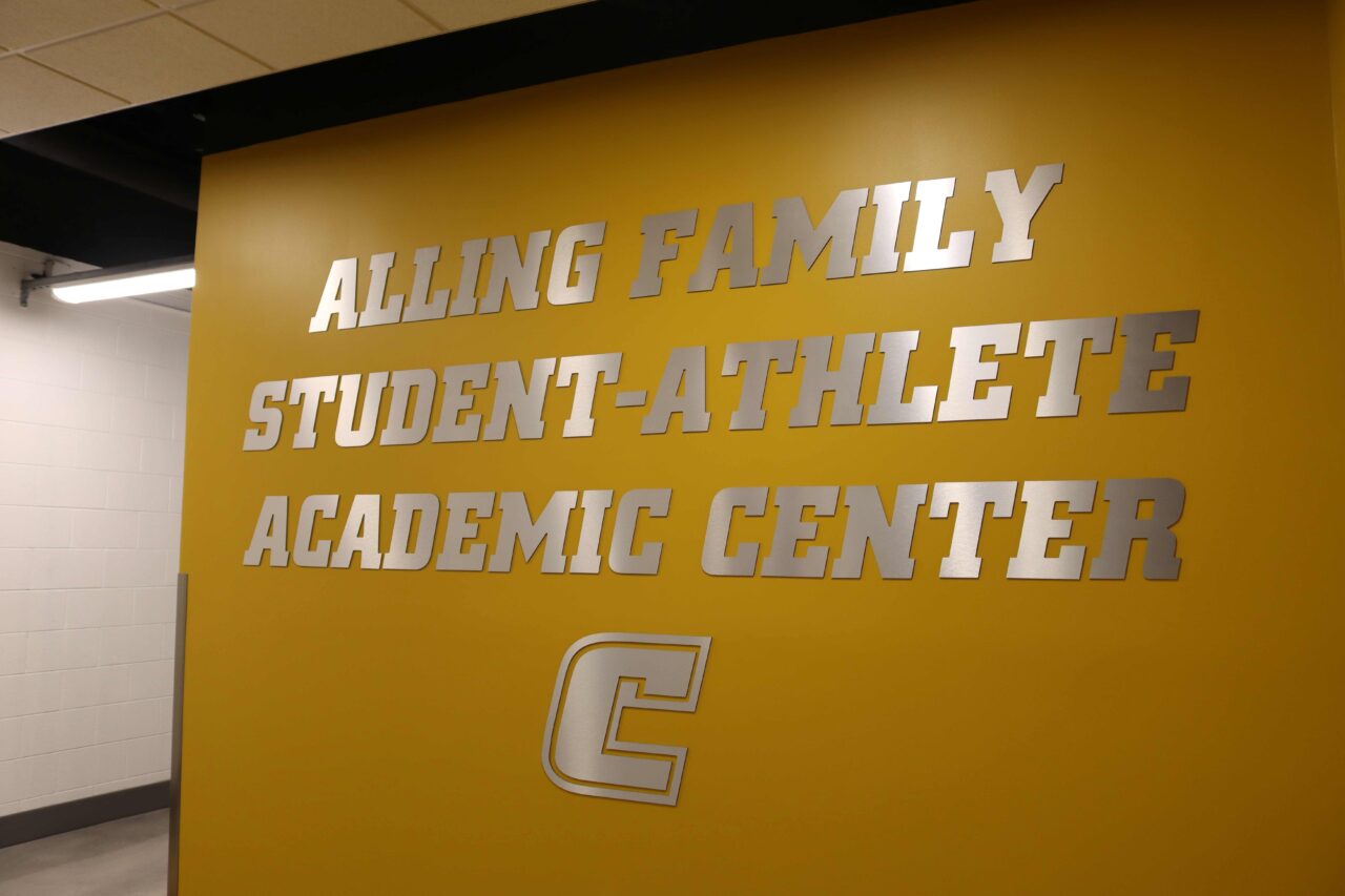 The sign reading Alling Family Student-Athlete Academic Center on the wall outside the center