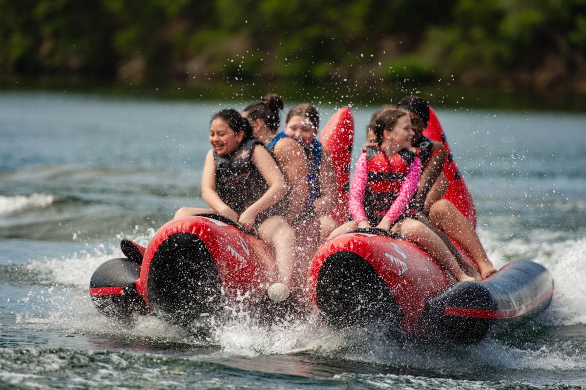 Girls sailing on a raft at Camp Ocoee