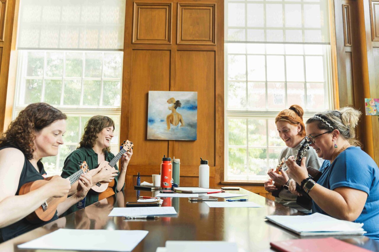 Educators hard at work composing a Blues song with the ukulele. Photo courtesy of Arts-Based Collaborative.