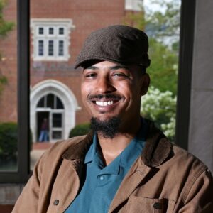 Student veteran Durand Henderson stands in front of Fletcher Hall