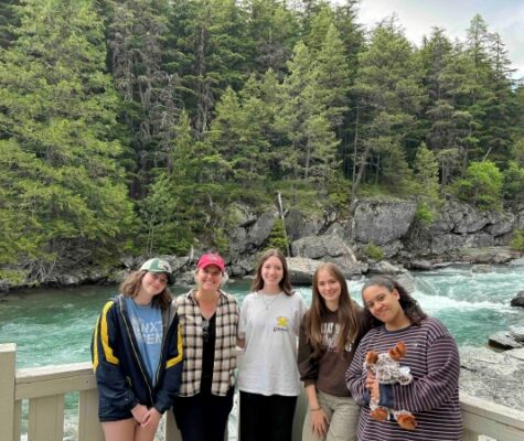 UTC's UReCA production team stand in front of a lake at Glacier National Park. From left: Anna Melby, editor-in-chief; Dr. Jayda Coons, faculty advisor; Ainsley Henderson, editor; Ellie Minneci, managing editor; and Ally McCoy, editor.