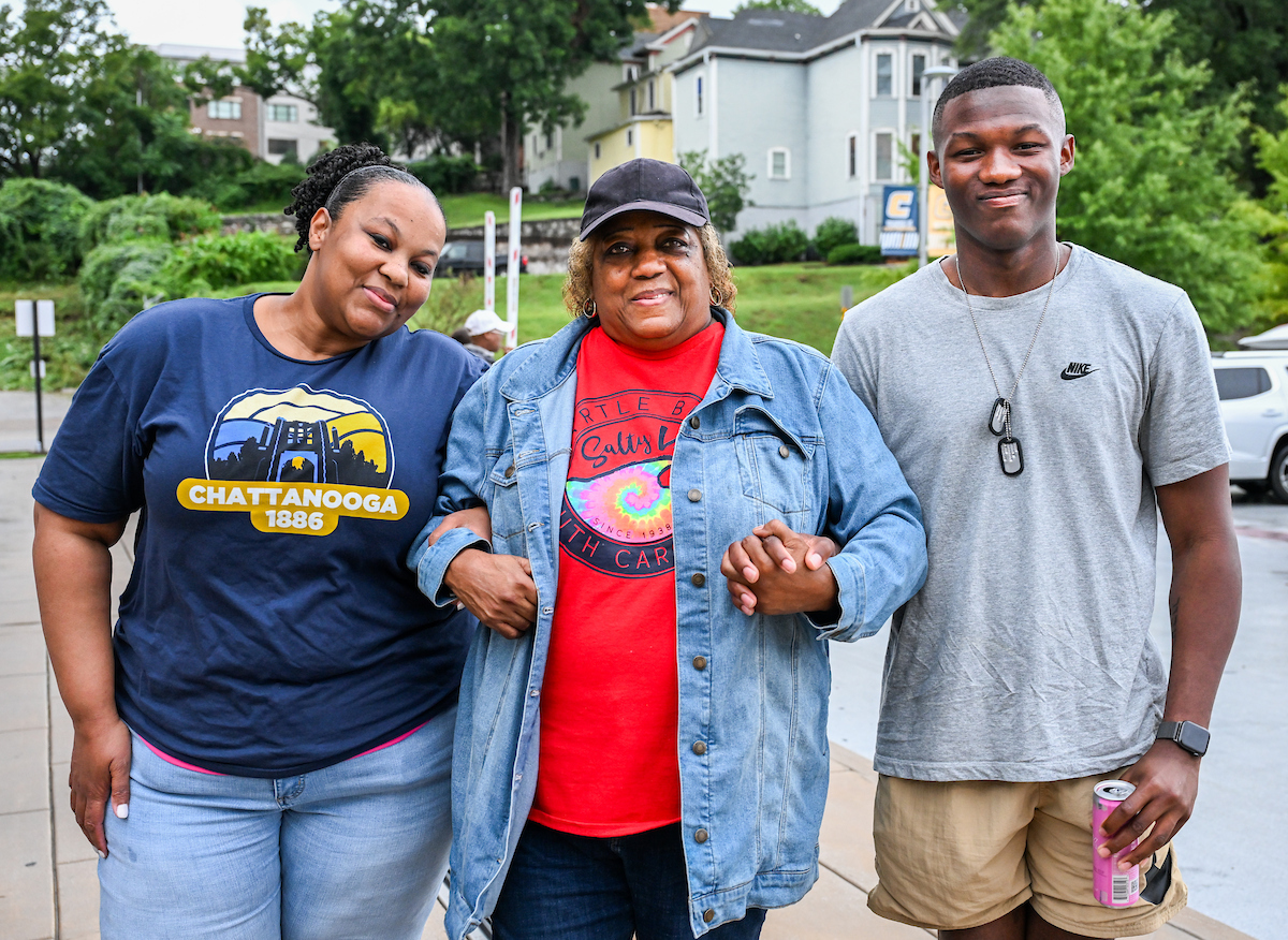 Darian Macon, his stepmother, Jona and his grandmother stand together outside of West Campus Housing.