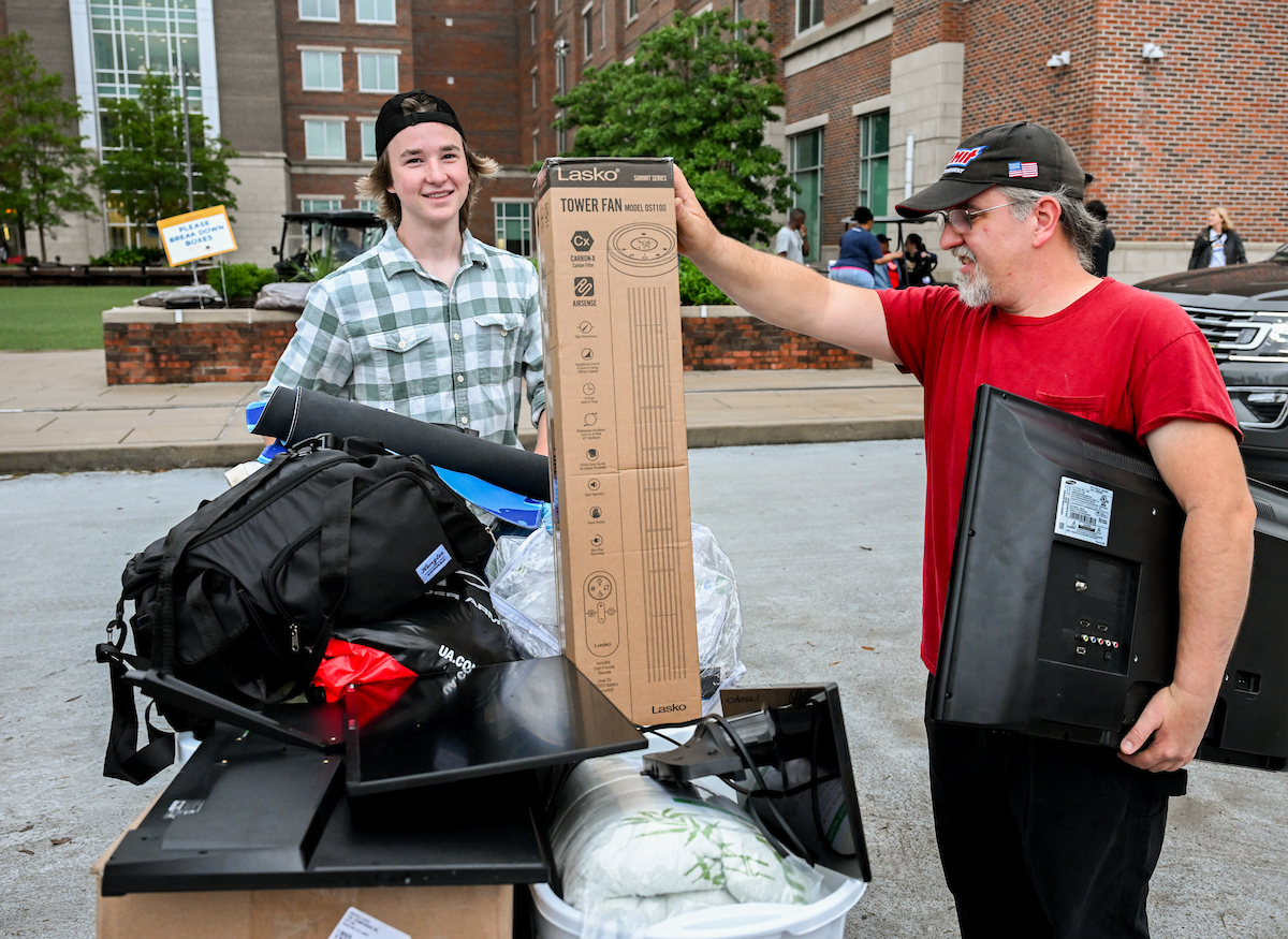 A family moves a student's belongings into West Campus Housing.