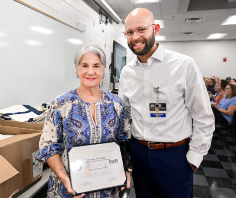 Chris Smith holds the framed certficate she won as the recipient of the Patriot Award. Standing next to her is School of Nursing faculty member Terry Ellis.
