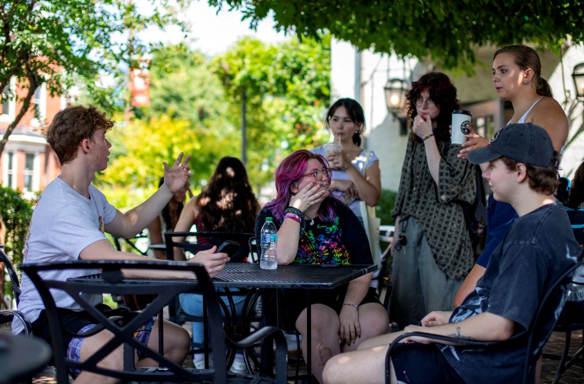 Students, both sitting and standing, talking about the City as Text event