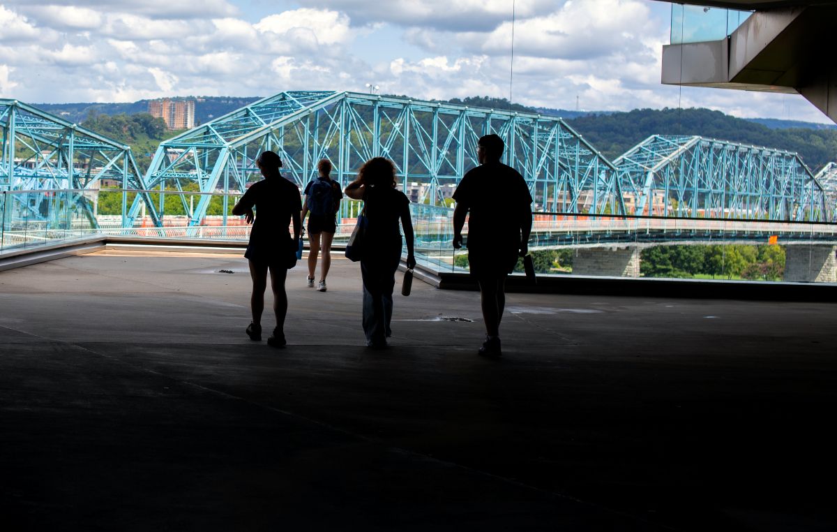 Shadows of students in the foreground with the Walnut Street Bridge in the background
