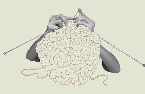 A pair of hands knitting with needles, with the yarn forming a human brain