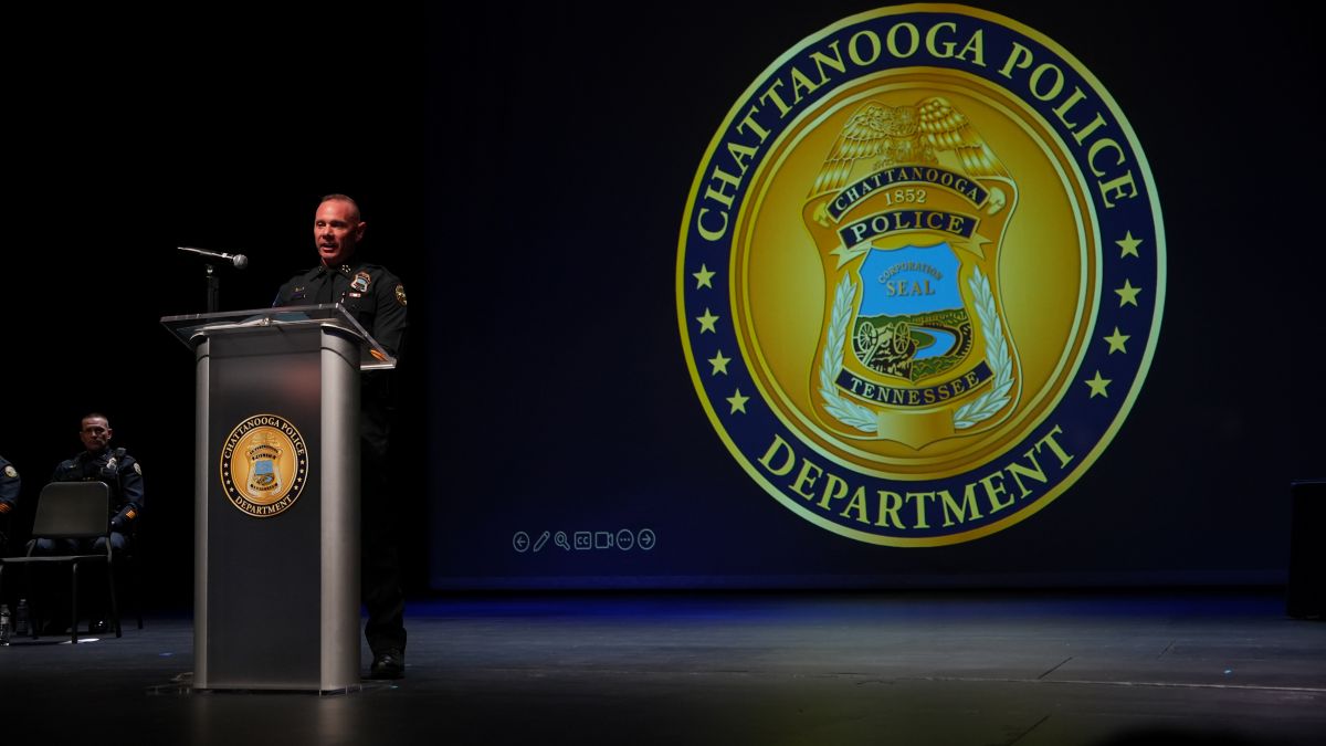 Chattanooga Police Department Chief John Chambers stands at the podium in front of the CPD logo