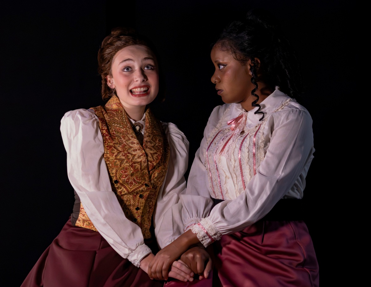 Mina (brunette, in the gold/brown vest) is played by sophomore Theatre major Cameron Schulz. Lucy (white lacy top with pink trim) is played by junior Theatre major Kyra Hollmon.