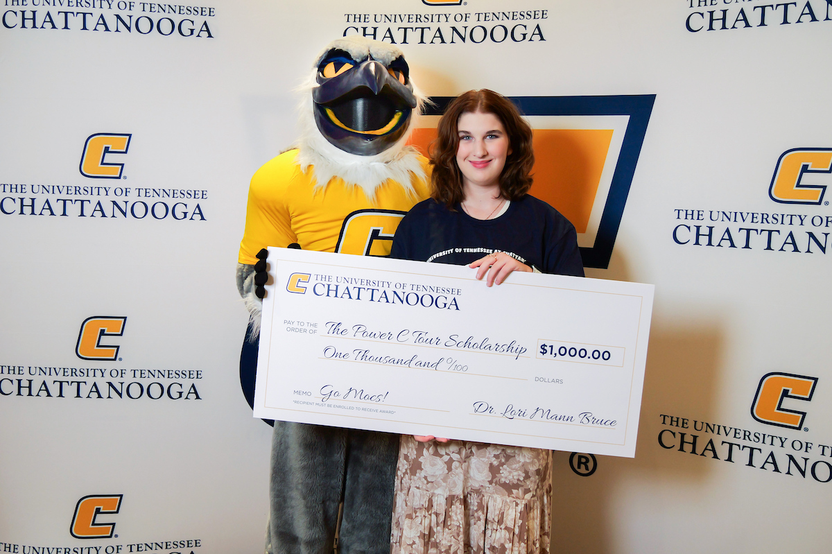 Scrappy poses with high school senior Eleanor Jordan and a $1,000 Power C Tour Scholarship check