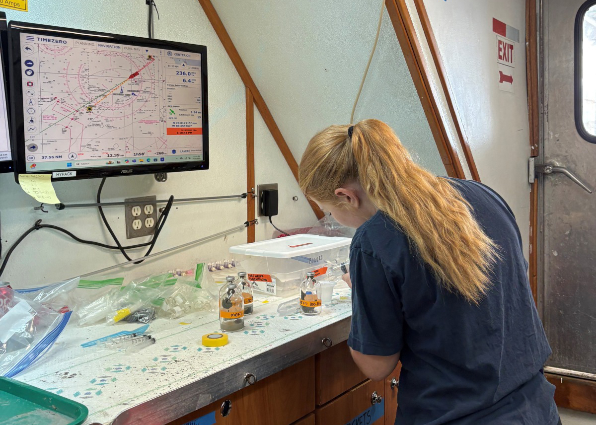 Rebecca Nix at a workstation doing research during her summer REU experience