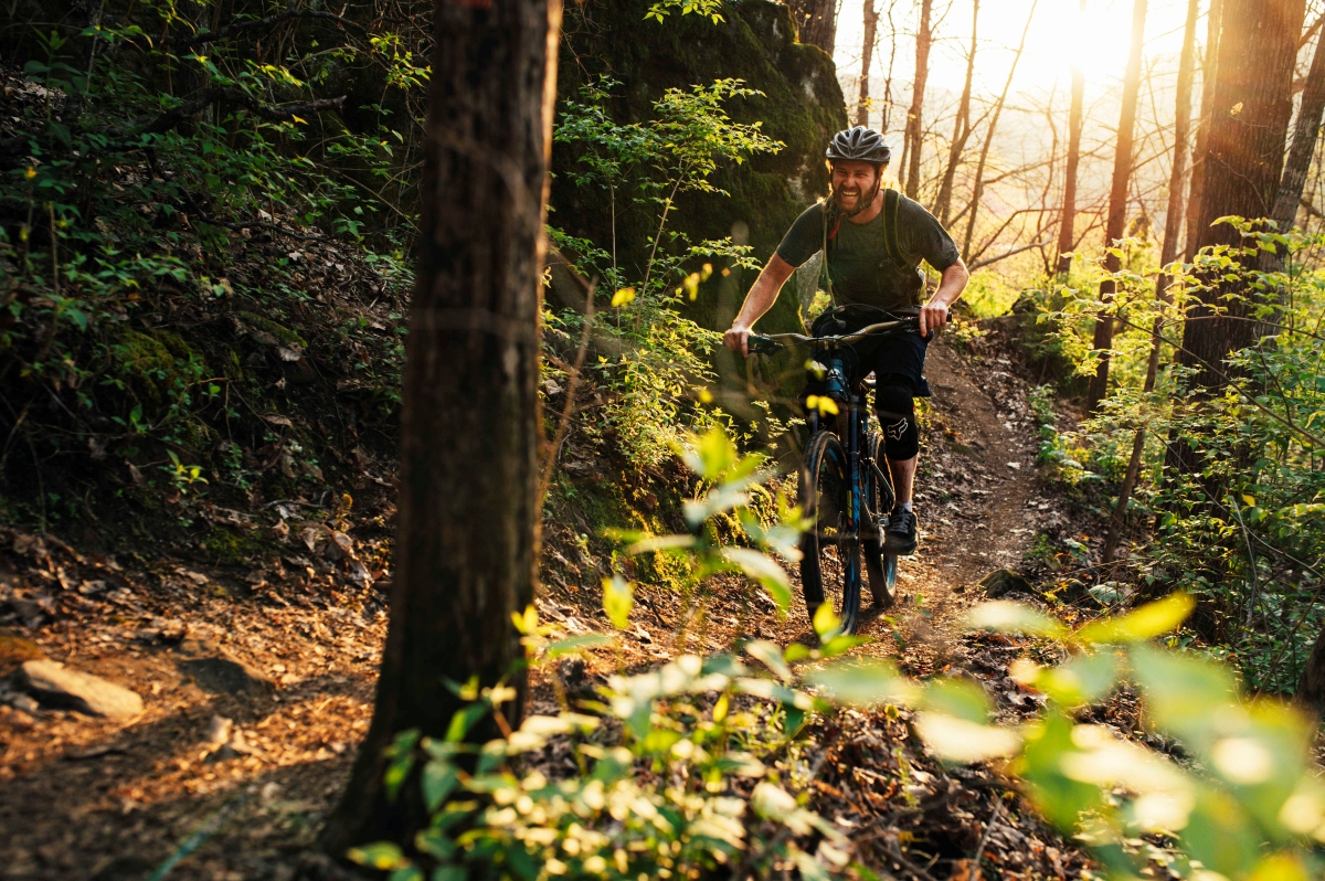 Bicyclist Rich Moore on a Raccoon Mountain bicycle trail with trees along the trail