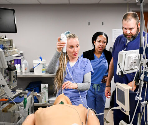 Nurse anesthesist training with nurses practicing their skills during an airways workshop
