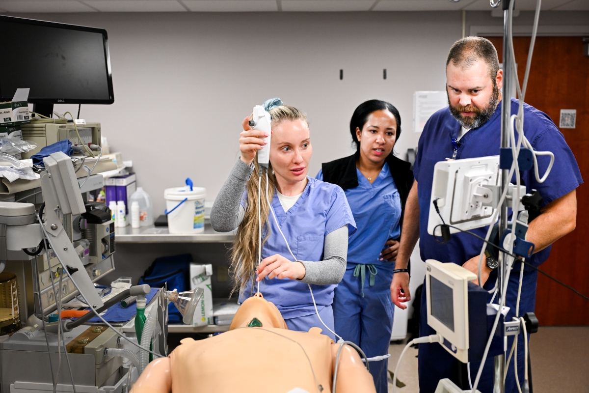 Nurse anesthesist training with nurses practicing their skills during an airways workshop