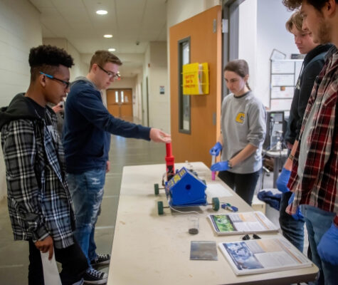 High school students at a past College Quest event getting a tour of an engineering lab