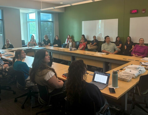 A group of students sitting in a UTC Library conference room at the URaCE SEARCH Award meeting