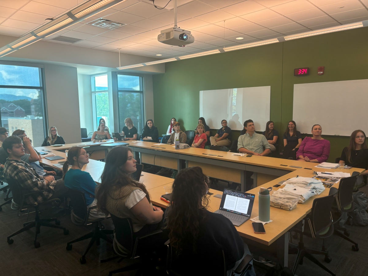 A group of students sitting in a UTC Library conference room at the URaCE SEARCH Award meeting