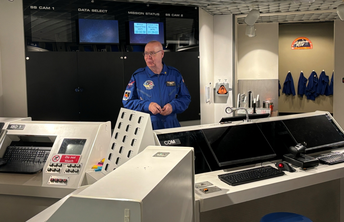 Bill Floyd stands in the simulator command room.