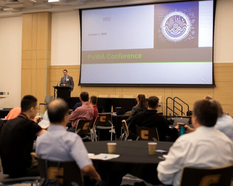 A speaker at the podium for the POWA Conference