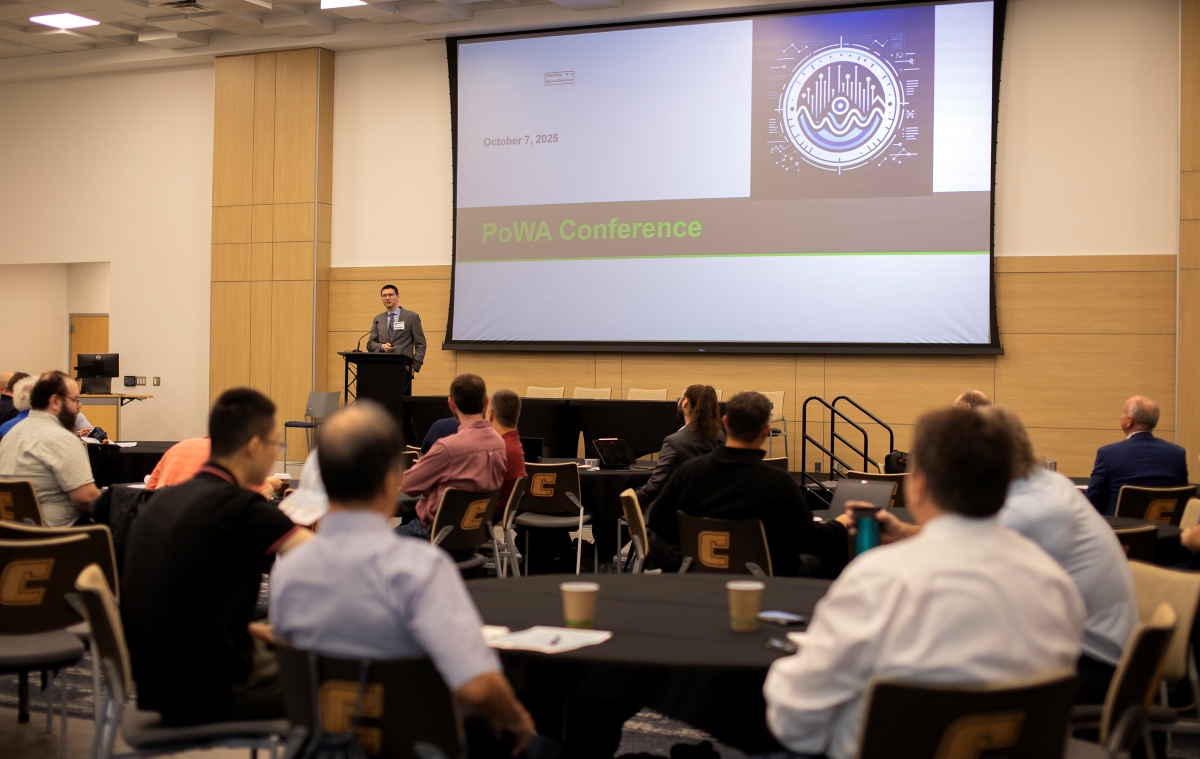A speaker at the podium for the POWA Conference